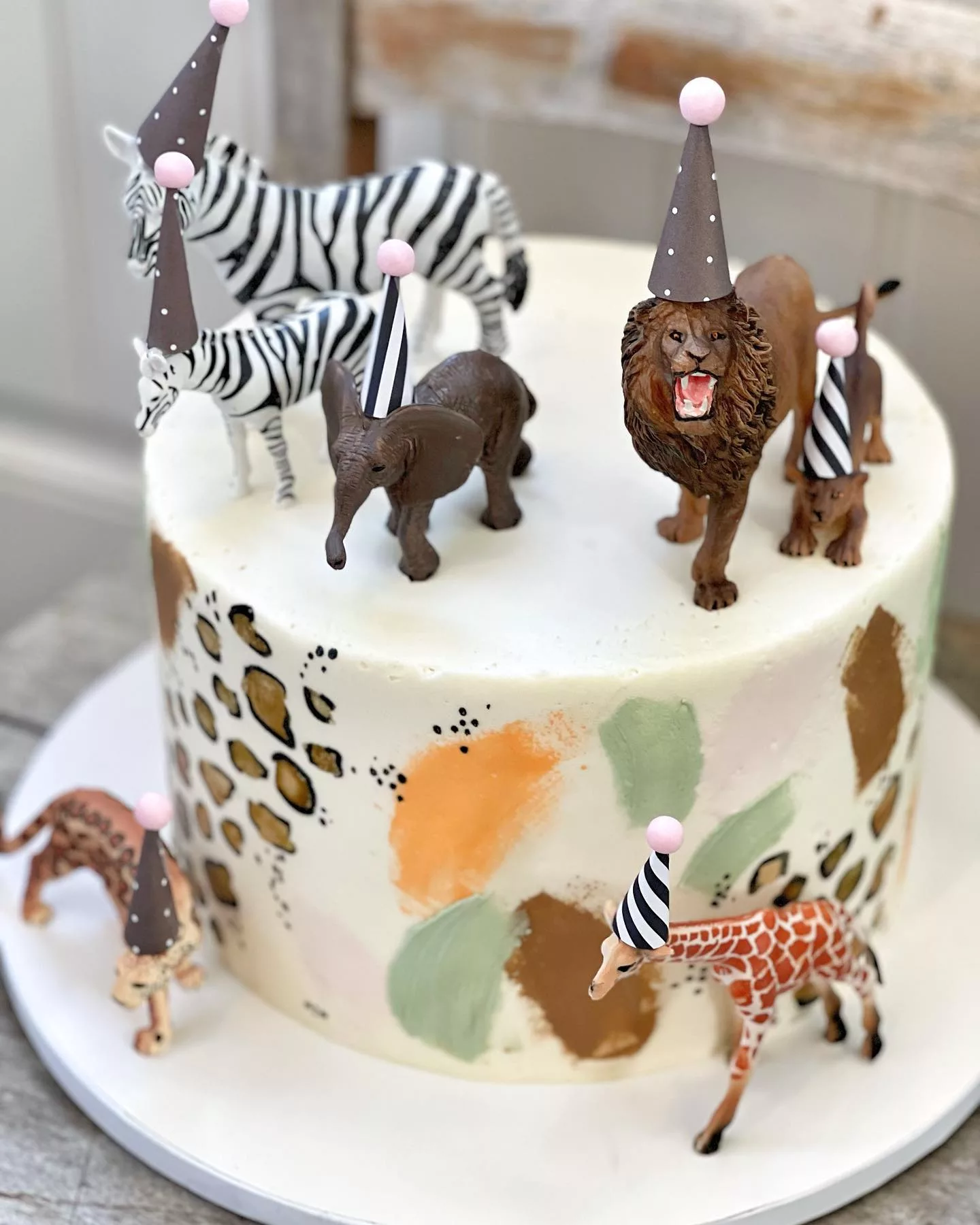 muted colors and animal patterns safari birthday cake